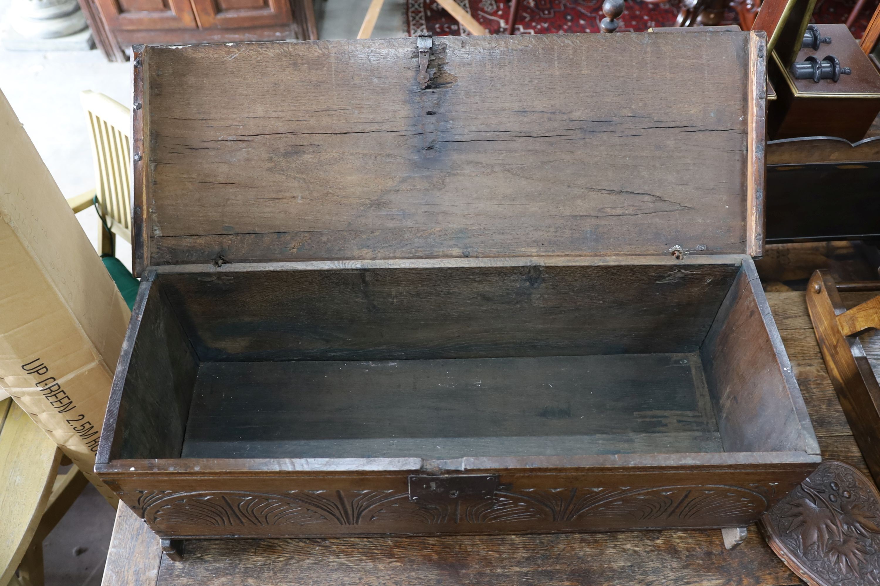 A 17th century carved oak six plank coffer, W 99, D 36, H 38cms.